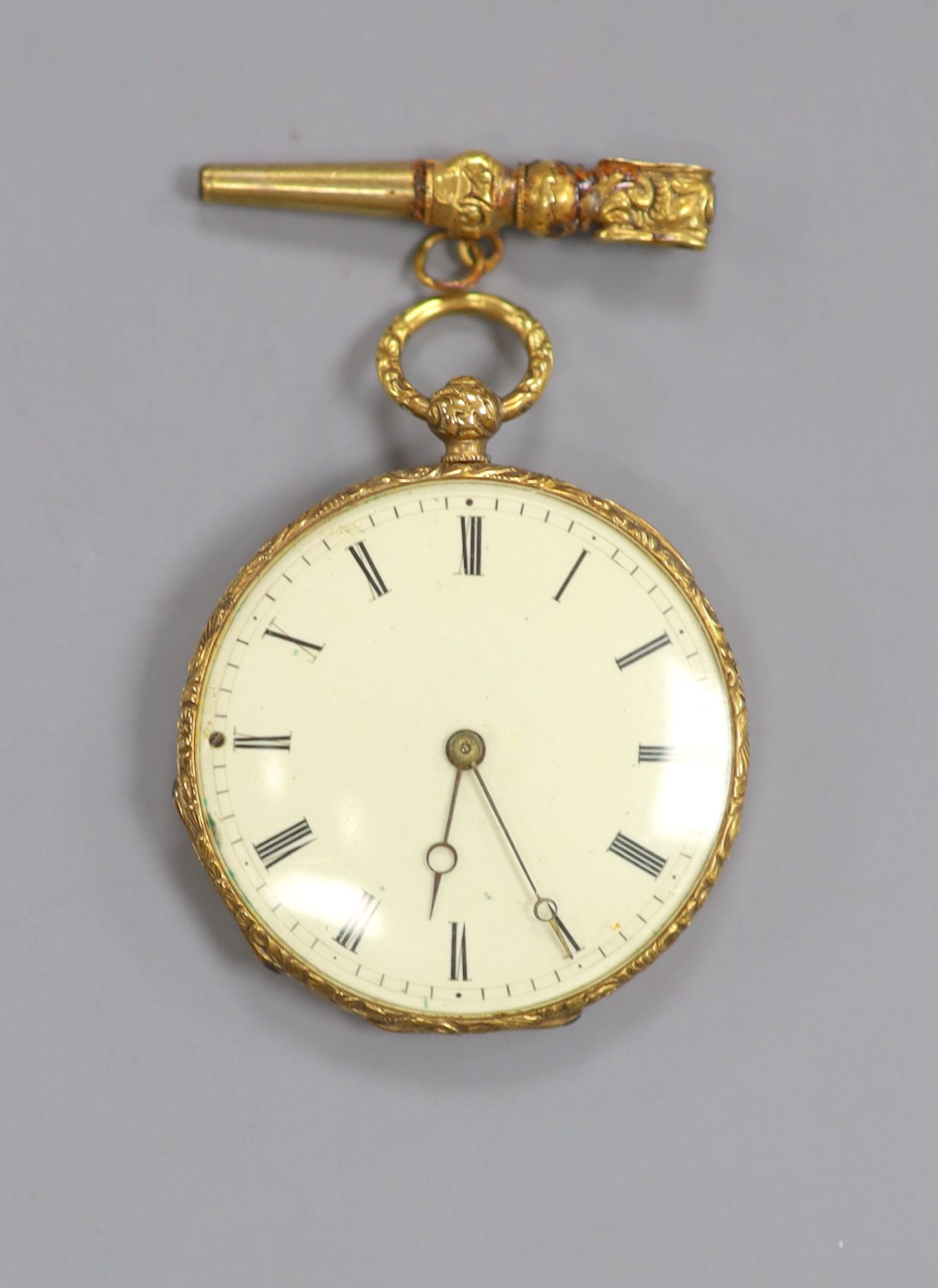 An early 20th century Swiss yellow metal open face fob watch and key, case diameter 27mm, gross 13.7 grams.